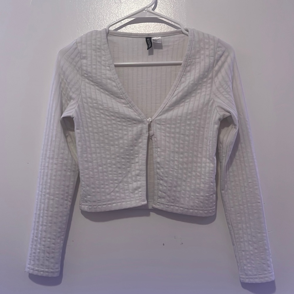 White long sleeve fitted v neck top with two bottons